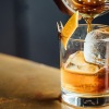 a person pours a drink into a glass
