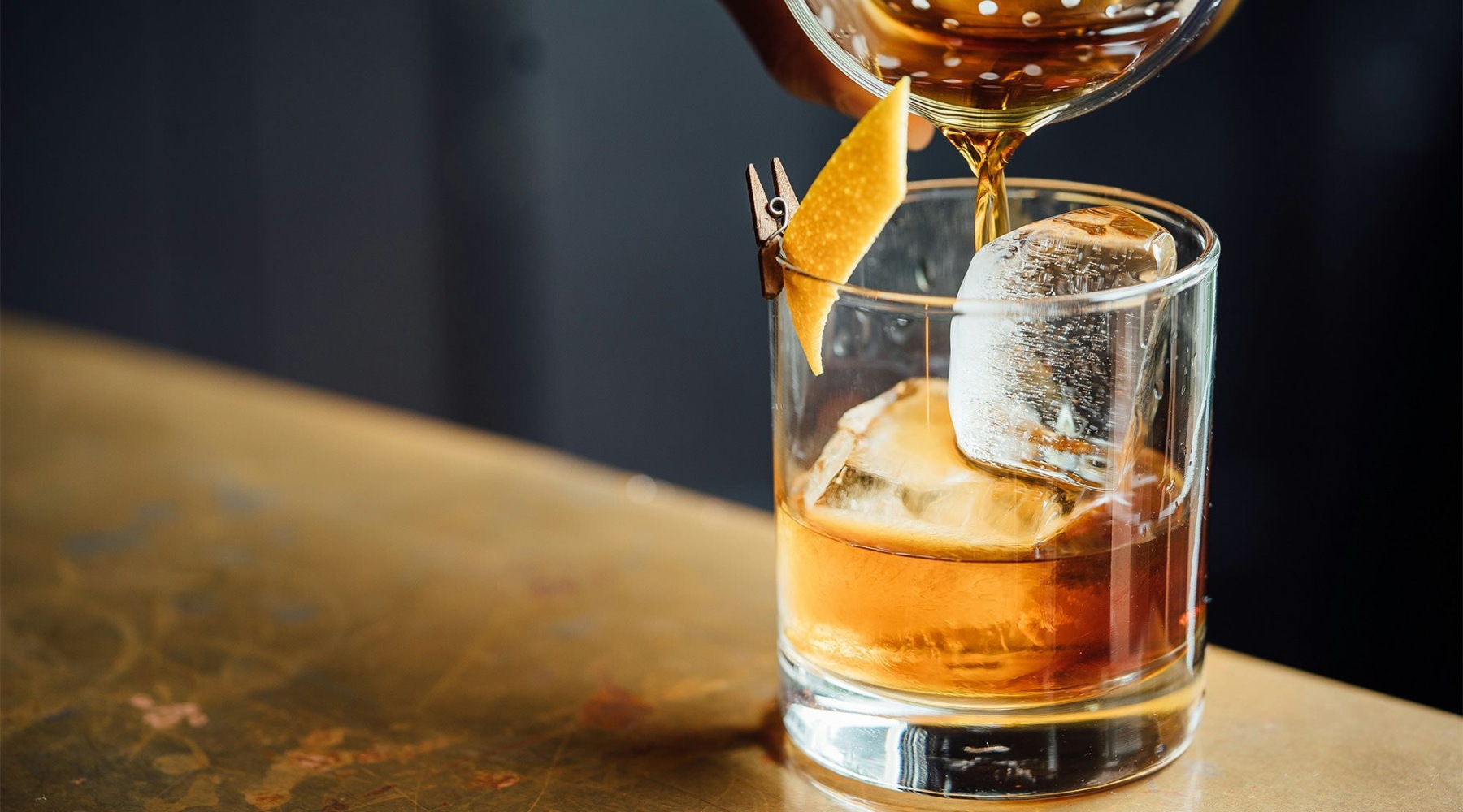The essence of exceptional living a person pours a drink into a glass