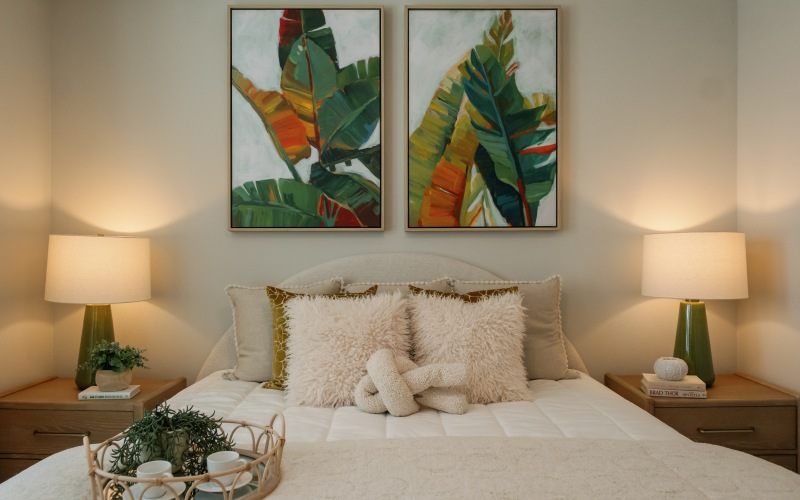Warm bedroom with colorful art and lamps