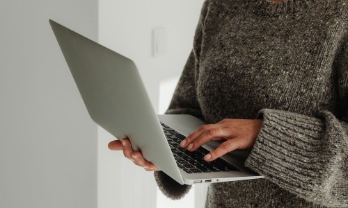 a laptop being held