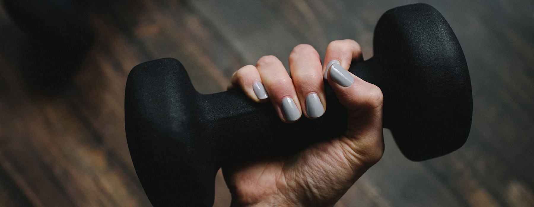 a person's hand holding a dumbbell
