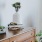 a dresser with a vase of plants on top